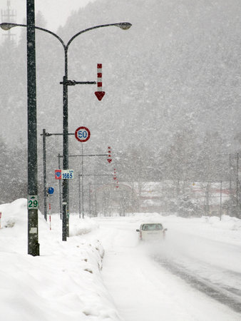 Hokkaido,Japan - February 25, 2023: Fixed-post delineators or fletchings used on a road in Hokkaido, Japanの写真素材