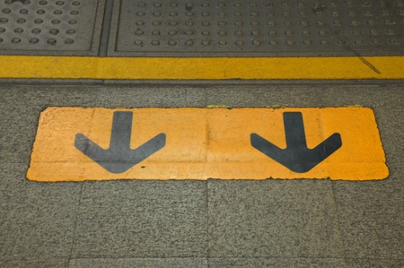 Arrow sign on floor, Exist symbol at sky train station Bangkokの写真素材