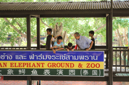 NAKHONPRATOM PROVINCE THAILAND-APRIL,4 :Family of Traveler see crocodile show on April 04,2012 in Nakornprotom province,Thailand.