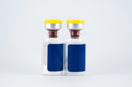 Yellow cap ampule on white backgroundの写真素材