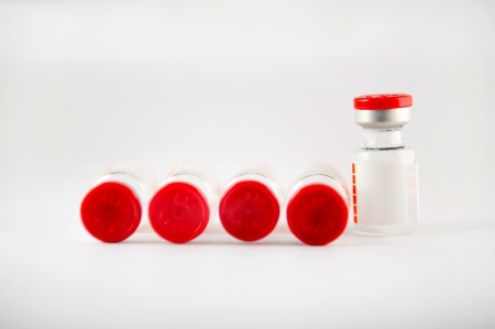 Red cap injections vials show medicine backgroundの写真素材