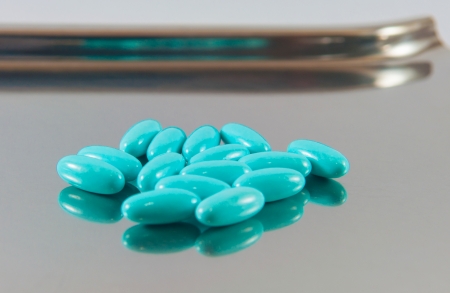 Blue tablet on dispensing metal trayの写真素材