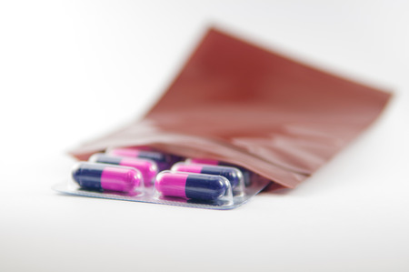 Medicine capsule blister pack in brown dispensing plastic bagの写真素材