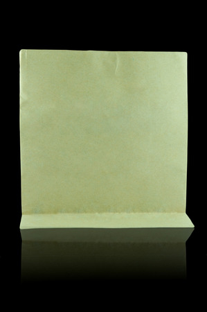 Brown paper bag and shadow effect on black backgroundの写真素材