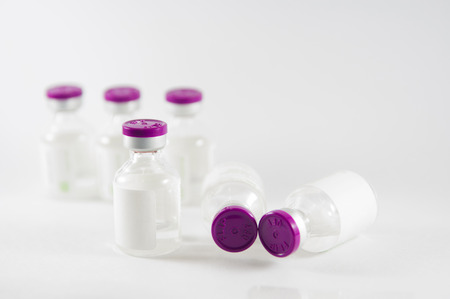 Purple cap injection vials show medicine conceptの写真素材