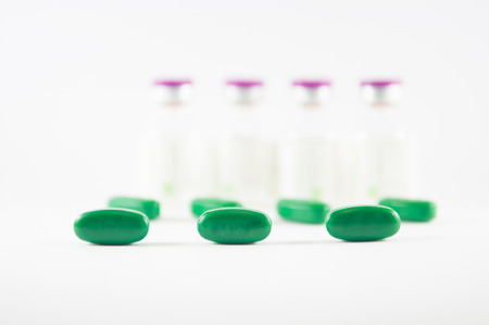 Green tablet on medicine background
