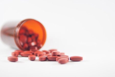 Brown tablet on medicine bottle backgroundの写真素材