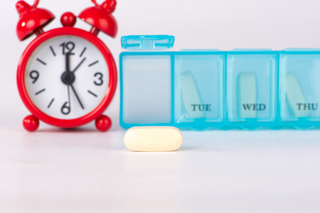 Yellow tablet and medicine time backgroundの写真素材