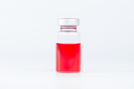 Red liquid in injection vialの写真素材