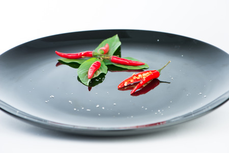 Fresh chili on black dish and reflexの写真素材