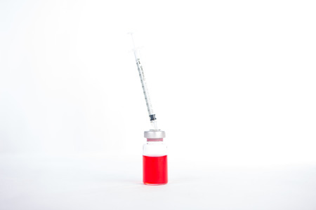 Action syringe put on rubber on injection vialsの写真素材