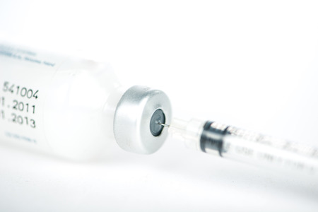 Injection preparation with vial and syringe on whiteの写真素材