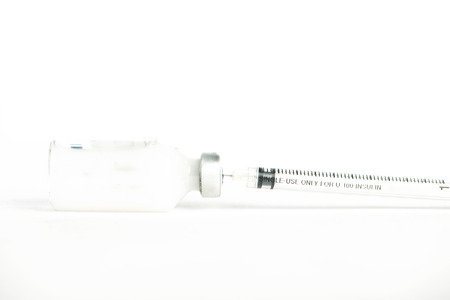 Closed up Injection preparation with ampoule and syringe on whiteの写真素材