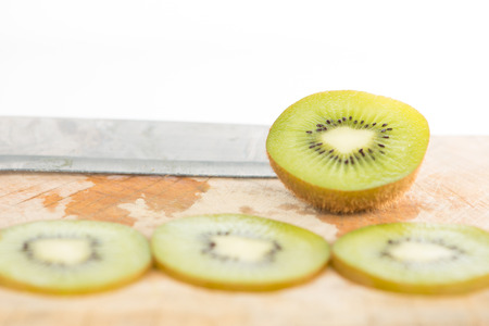 Closed up sliced kiwi fruit on wood floorの写真素材