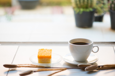 A cup of coffee and golden threads cakeの写真素材