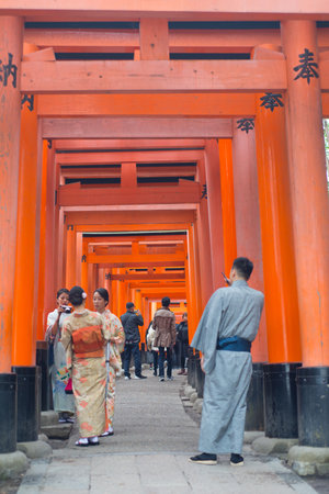 Kyoto, Japan - November 12, 2018:Japanese girl in kimono dress walk and see Red torii at Fushimi Inari-taisha shrine in Kyoto,Japanのeditorial素材