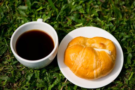 A white cup and black coffee with Croissant with cheeseの写真素材