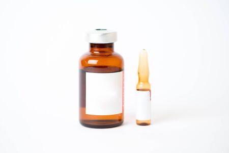 Brown glass vial and ampule with label on whiteの写真素材