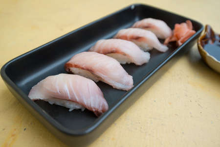 Closed up japanese sushi Maki in black dish show food backgroundの写真素材