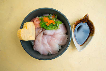 Closed up japanese rice and raw fish or fish don