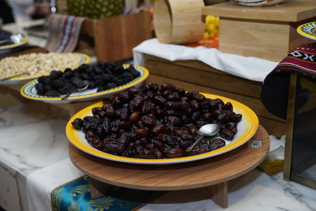 A lavish display of succulent dates elegantly arranged on a wooden platter, inviting guests to enjoy...