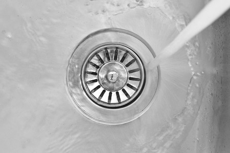 water flowing down the hole of kitchen sink