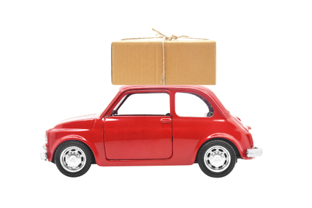 Parcel on red car isolated on white backgroundの写真素材
