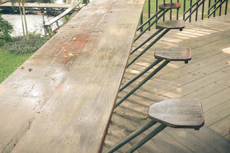 abandoned wooden porch with fall leaves on the wooden floorの写真素材