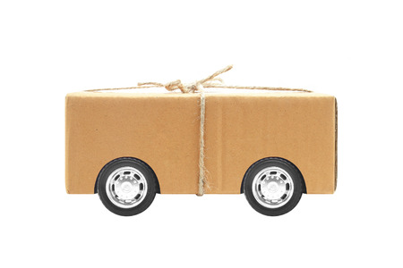 parcel post box with automotive wheels isolated on white backgroundの写真素材