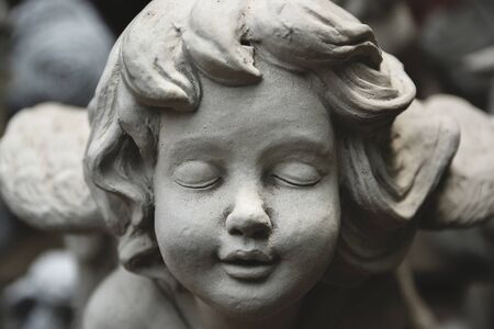 close up face of little cupids statueの写真素材