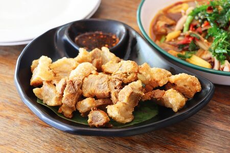 deep fried pork belly with fish sauce on dining tableの写真素材