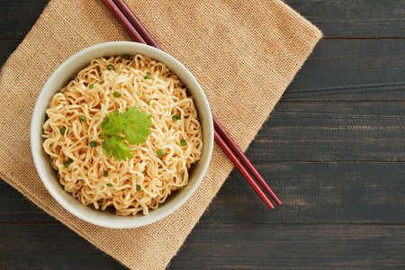 Instant noodles in the bowl on wooden tableの写真素材