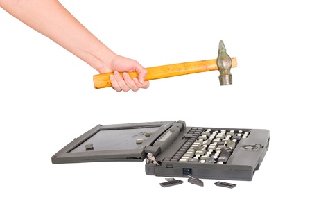 hand with a hammer destroys laptopの写真素材
