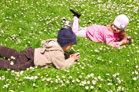Boy and girl playing in the parkの写真素材