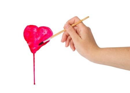 hand with brush drawing shape of heart isolated on whiteの写真素材