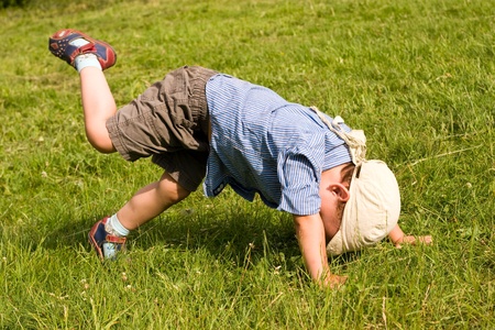 Running boy fall down in parkの写真素材