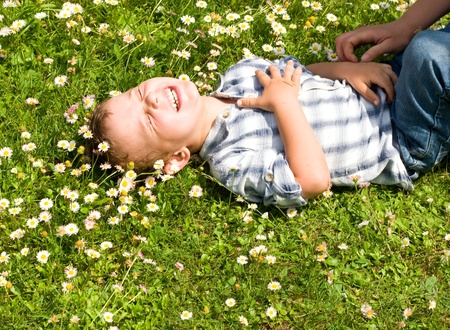 Little boy laying in the grassの写真素材