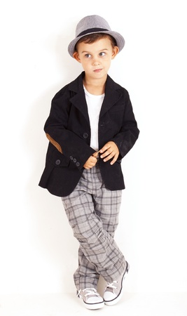 Pensive cool pretty stylish little boy isolated on white backgroundの写真素材