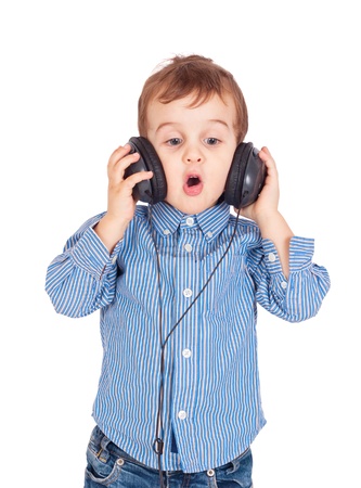 Portrait of little boy with headphones and singing  Isolated on white backgroundの写真素材