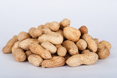 Peanuts in their shell textured food background.の写真素材