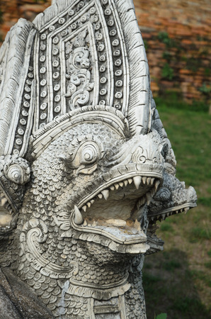 Carved stone statue protecting part of the Buddhist templeの写真素材