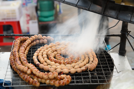 Grilling Round Thai Sausagesの写真素材