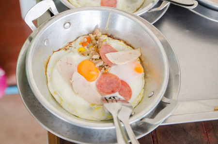 Homemade Thai style fried egg in pan with porkの写真素材