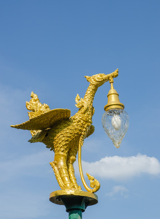 the Golden bird lantern on the top of poleの写真素材