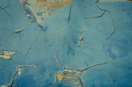 Closeup of cracked and peeling paint on an old car