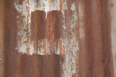 dirty and rusty brown color zinc plate wall for backgroundの写真素材