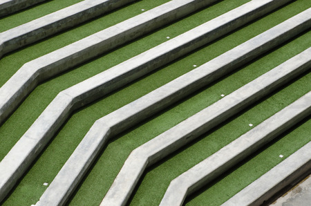 Concrete grandstand terrace in a green field.の写真素材