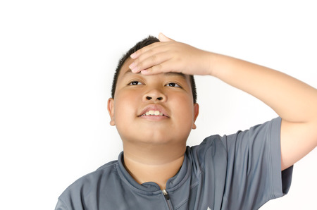 asian boy holding his head in painの写真素材