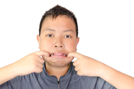 cute young asian boy thinking with white backgroundの写真素材
