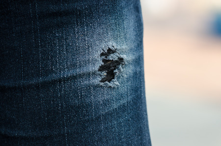 the closeup of torn jeans